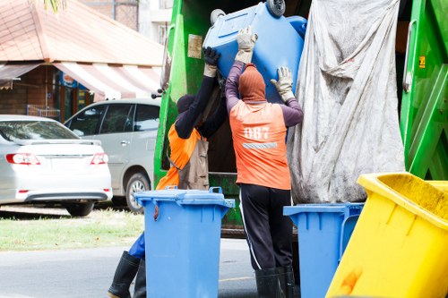Operator securing a skip load on a vehicle